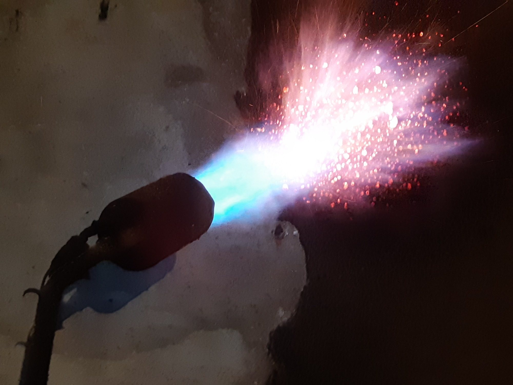 Photo de la flamme d'un chalumeau dirigée sur une couche de tartre